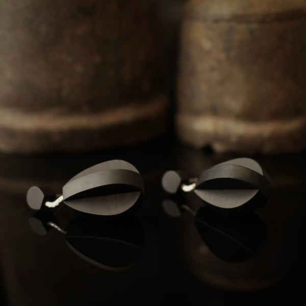 Deoir - Teardrop shaped wooden drop earrings made from two interlocking planes. Handmade by jewellery designer Rowena Sheen 