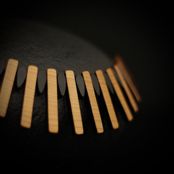 Close up of Cadence necklace - wood rectangle and black teardrop shapes. Handmade by Rowena Sheen 