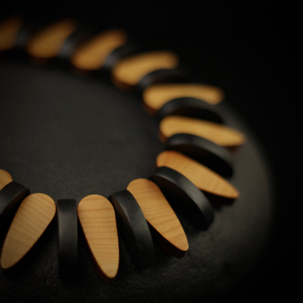 Trace - Necklace in Yew wood, Close up details of oval black and wood sections