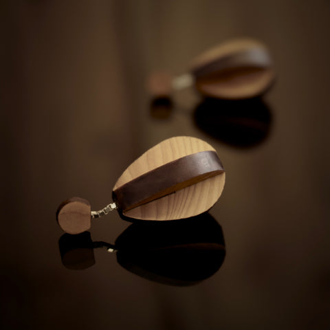 Deoir - Teardrop shaped wooden drop earrings made from two interlocking planes. Handmade by jewellery designer Rowena Sheen 